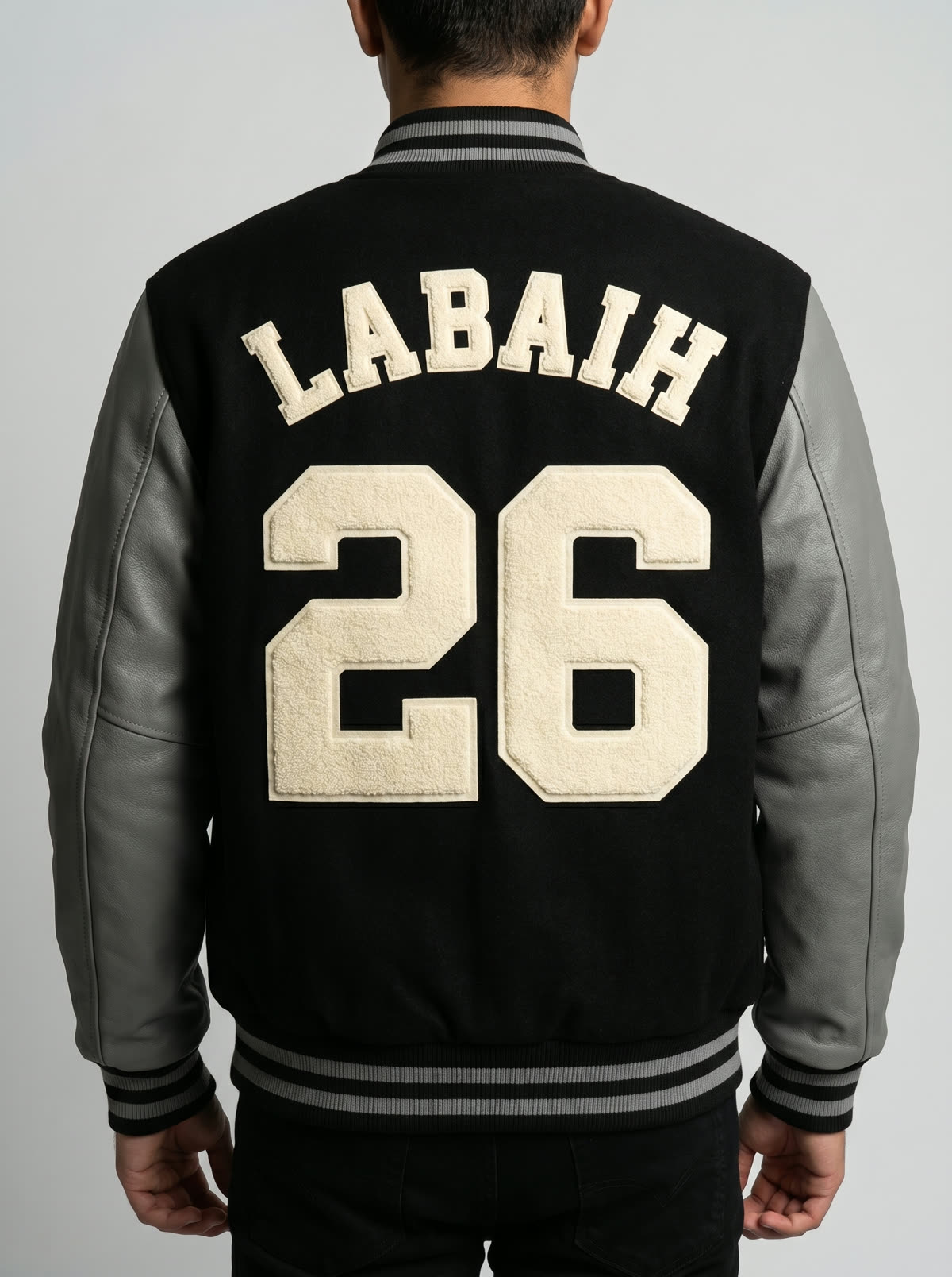 Back of a custom Labaih varsity jacket with cream chenille lettering reading LABAIH 26